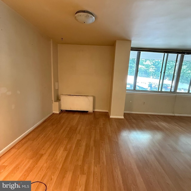 5565 Columbia Pike Unit 210, Arlington, VA 22204 - spare room with radiator heating unit and wood finished floors