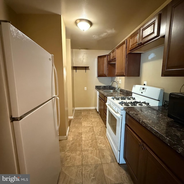 5565 Columbia Pike Unit 210, Arlington, VA 22204 - kitchen featuring white appliances and dark stone counters