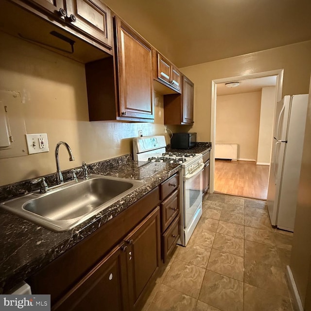 5565 Columbia Pike Unit 210, Arlington, VA 22204 - kitchen featuring white appliances and dark stone counters