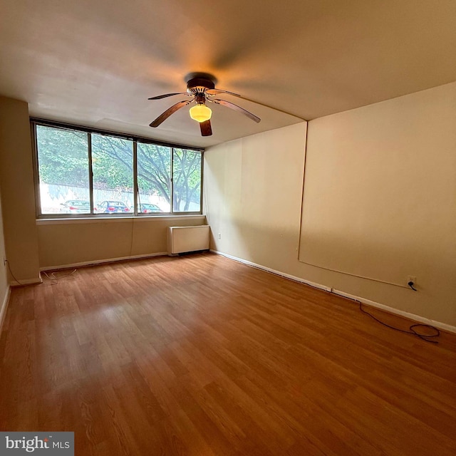5565 Columbia Pike Unit 210, Arlington, VA 22204 - unfurnished room featuring wood finished floors, a ceiling fan, and radiator