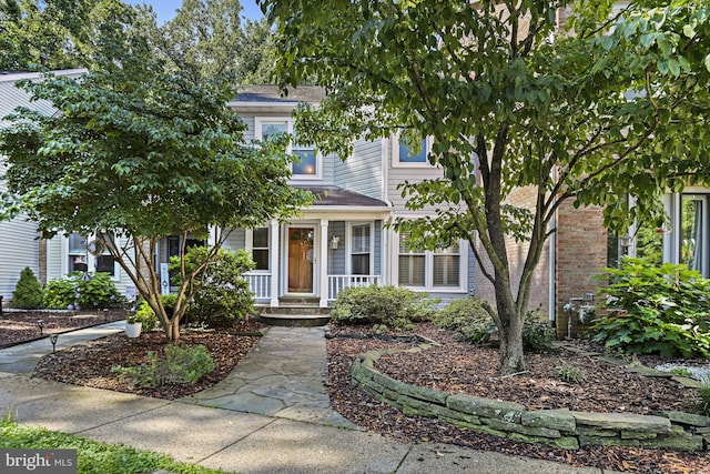 9405 Odyssey Ct, Burke, VA 22015 - view of property hidden behind natural elements with a porch