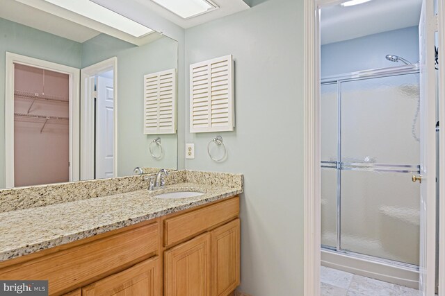 9405 Odyssey Ct, Burke, VA 22015 - full bath with a stall shower, vanity, and a walk in closet