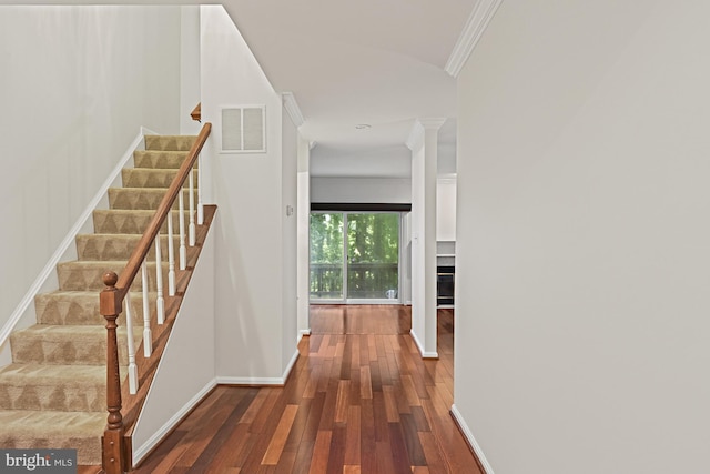 9405 Odyssey Ct, Burke, VA 22015 - hall with ornamental molding, wood-type flooring, stairs, and decorative columns