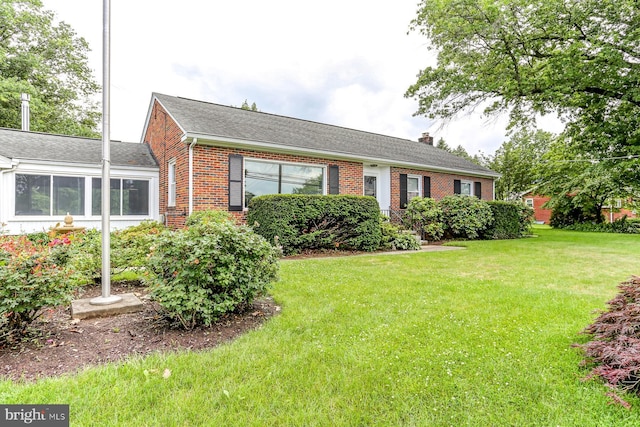 518 E Winding Hill Rd, Mechanicsburg, PA 17055 - ranch-style home with brick siding, a front lawn, a chimney, and a shingled roof