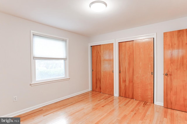 518 E Winding Hill Rd, Mechanicsburg, PA 17055 - unfurnished bedroom with multiple closets and wood finished floors
