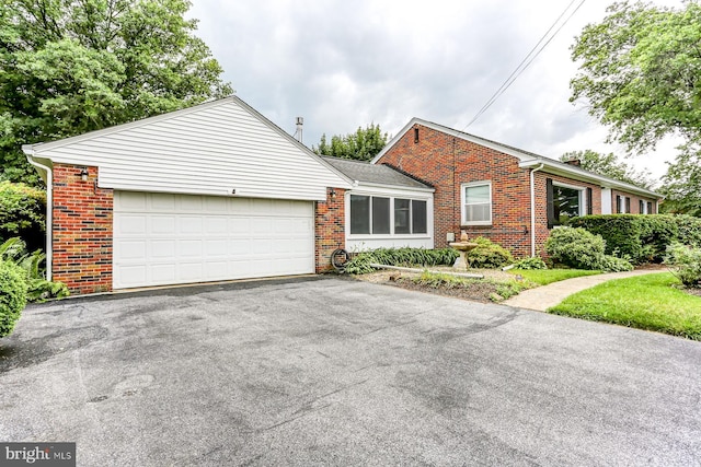 518 E Winding Hill Rd, Mechanicsburg, PA 17055 - view of front of home with brick siding, asphalt driveway, a garage, and a chimney