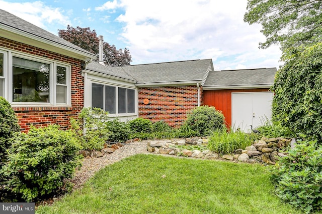 518 E Winding Hill Rd, Mechanicsburg, PA 17055 - view of home's exterior with brick siding, a lawn, and roof with shingles