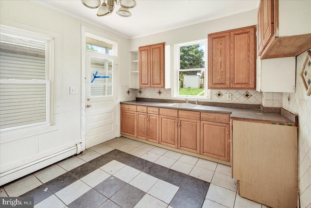607 Salem Ave, Hagerstown, MD 21740 - kitchen with baseboard heating, dark countertops, a chandelier, decorative backsplash, and ornamental molding