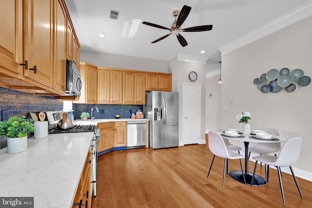 32 Brewster Ct, Pennington, NJ 08534 - kitchen with stainless steel appliances, crown molding, tasteful backsplash, a ceiling fan, and light wood-style flooring