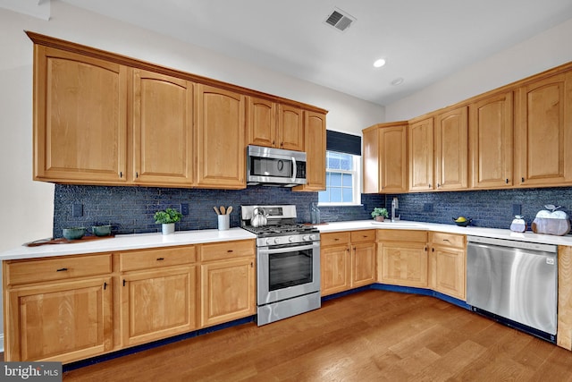 32 Brewster Ct, Pennington, NJ 08534 - kitchen featuring stainless steel appliances, light wood-style floors, tasteful backsplash, light countertops, and recessed lighting
