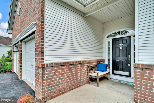 32 Brewster Ct, Pennington, NJ 08534 - doorway to property with brick siding, an attached garage, and asphalt driveway