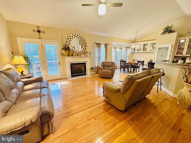 61 Kirby Ln, Stafford, VA 22554 - living room with vaulted ceiling, light wood-style floors, a glass covered fireplace, and healthy amount of natural light