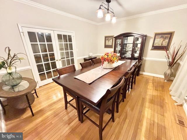61 Kirby Ln, Stafford, VA 22554 - dining room featuring french doors, light wood-style flooring, and crown molding