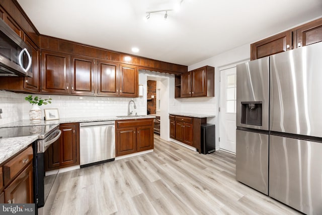 661 Schoolside Ln, Swarthmore, PA 19081 - kitchen with stainless steel appliances, tasteful backsplash, light wood-style flooring, and light stone counters
