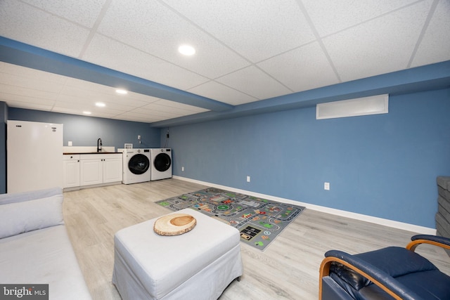 661 Schoolside Ln, Swarthmore, PA 19081 - living room featuring washer and dryer, light wood-style flooring, a paneled ceiling, and bar