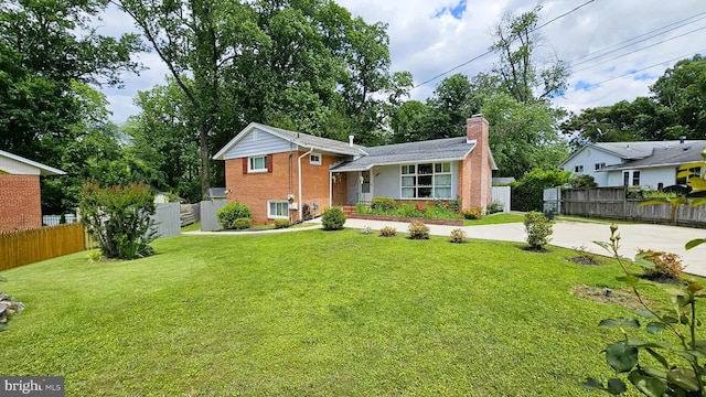 4753 Pomponio Pl, Annandale, VA 22003 - split level home featuring a chimney, concrete driveway, and brick siding