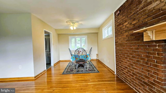 4753 Pomponio Pl, Annandale, VA 22003 - dining room featuring wood finished floors, ceiling fan, and brick wall