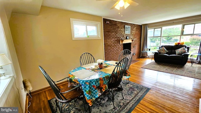 4753 Pomponio Pl, Annandale, VA 22003 - dining room featuring plenty of natural light, wood finished floors, a ceiling fan, and a brick fireplace