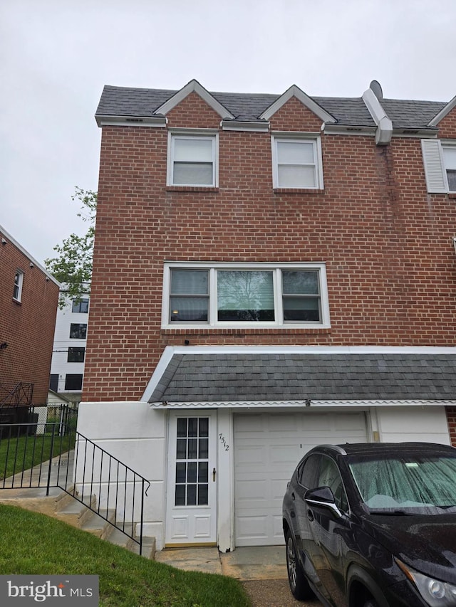 7512 Valley Ave, Philadelphia, PA 19128 - view of front facade with brick siding, a garage, and a shingled roof