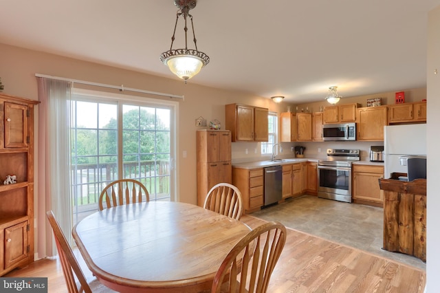 909 S 3rd St, Lebanon, PA 17042 - kitchen with appliances with stainless steel finishes, light countertops, hanging light fixtures, and light wood-style flooring