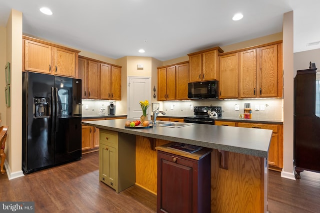 1080 Arbour Ln, Quakertown, PA 18951 - kitchen with black appliances, dark wood-style flooring, tasteful backsplash, recessed lighting, and a center island with sink
