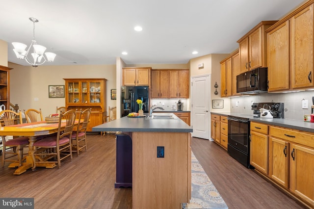 1080 Arbour Ln, Quakertown, PA 18951 - kitchen with black appliances, dark countertops, a chandelier, dark wood finished floors, and decorative backsplash