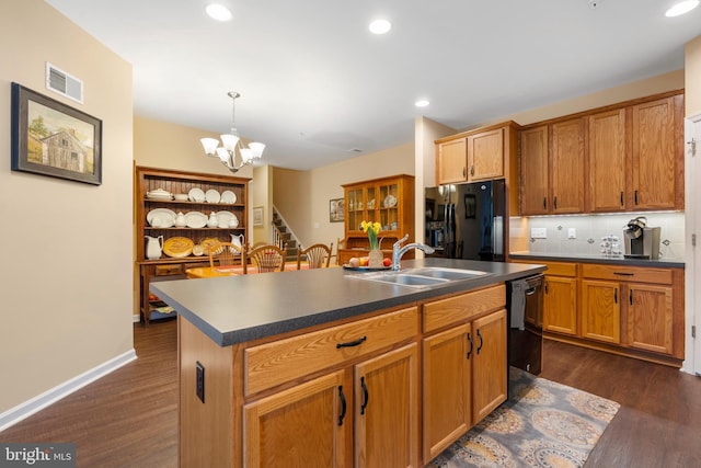 1080 Arbour Ln, Quakertown, PA 18951 - kitchen with black appliances, dark countertops, a chandelier, a kitchen island with sink, and dark wood-type flooring