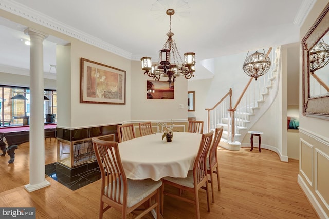 8162 Madrillon Ct, Vienna, VA 22182 - dining area with a chandelier, light wood-type flooring, crown molding, stairway, and decorative columns