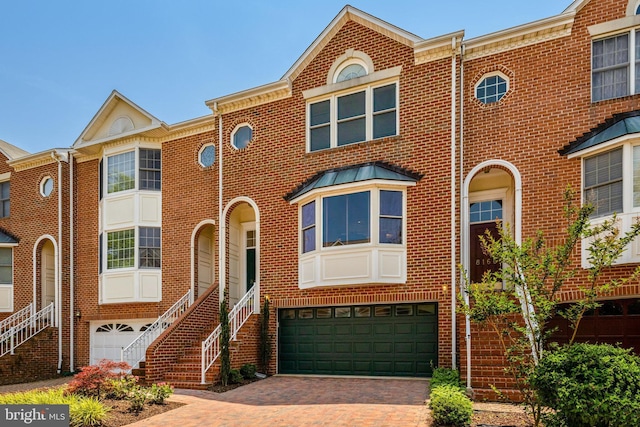8162 Madrillon Ct, Vienna, VA 22182 - view of front of property featuring brick siding, decorative driveway, a garage, and stairway