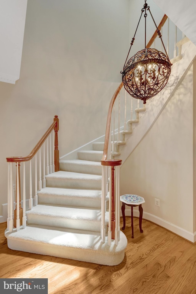 8162 Madrillon Ct, Vienna, VA 22182 - stairway with wood finished floors and a chandelier