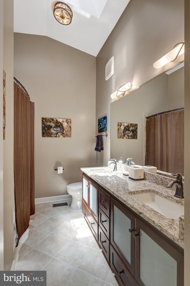 8162 Madrillon Ct, Vienna, VA 22182 - bathroom featuring double vanity, tile patterned flooring, curtained shower, and lofted ceiling