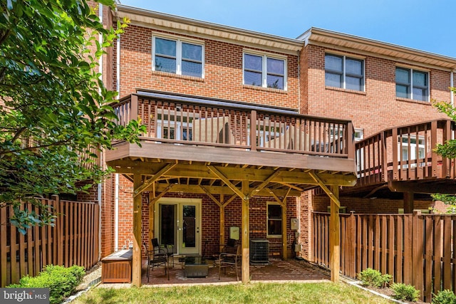 8162 Madrillon Ct, Vienna, VA 22182 - rear view of house with brick siding, a wooden deck, and a fenced backyard