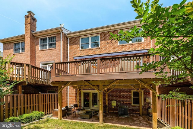 8162 Madrillon Ct, Vienna, VA 22182 - back of house featuring brick siding, a chimney, a patio, and a deck