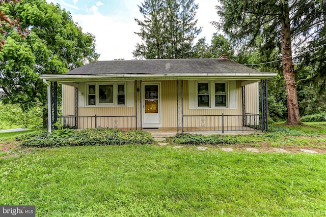 175 Dellville Rd, Duncannon, PA 17020 - view of front facade with covered porch, a front yard, and roof with shingles