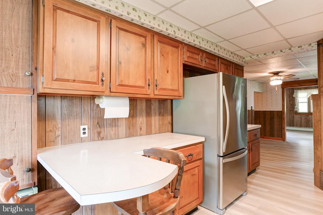 175 Dellville Rd, Duncannon, PA 17020 - kitchen with freestanding refrigerator, wood walls, a paneled ceiling, light countertops, and light wood-style flooring