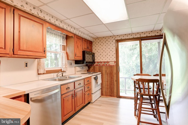 175 Dellville Rd, Duncannon, PA 17020 - kitchen featuring white appliances, a paneled ceiling, light wood finished floors, light countertops, and a wainscoted wall