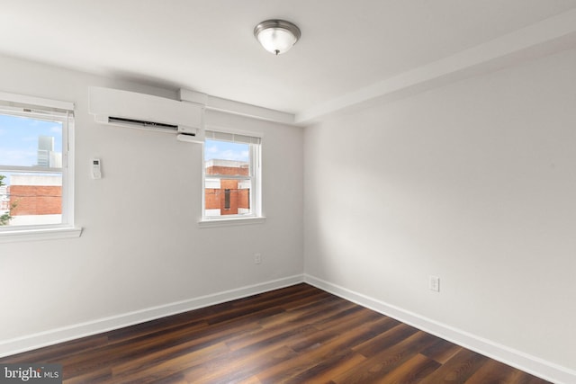 123 E Cross St, Baltimore, MD 21230 - spare room featuring a wall mounted air conditioner, healthy amount of natural light, and dark wood-style floors