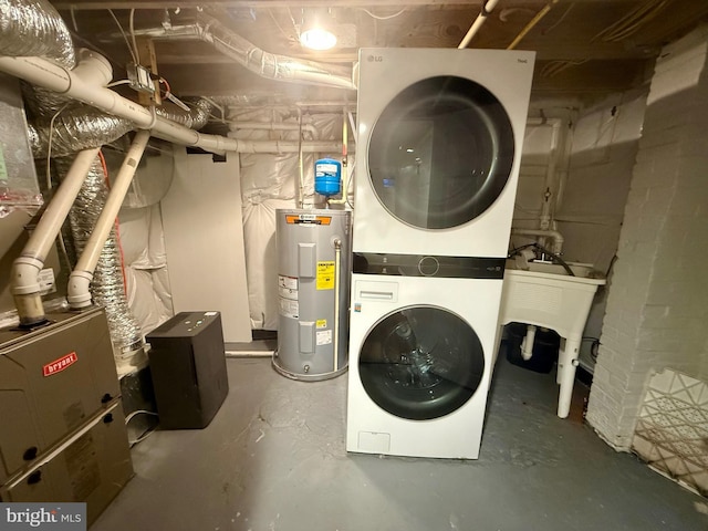 123 E Cross St, Baltimore, MD 21230 - washroom with electric water heater and stacked washer and clothes dryer
