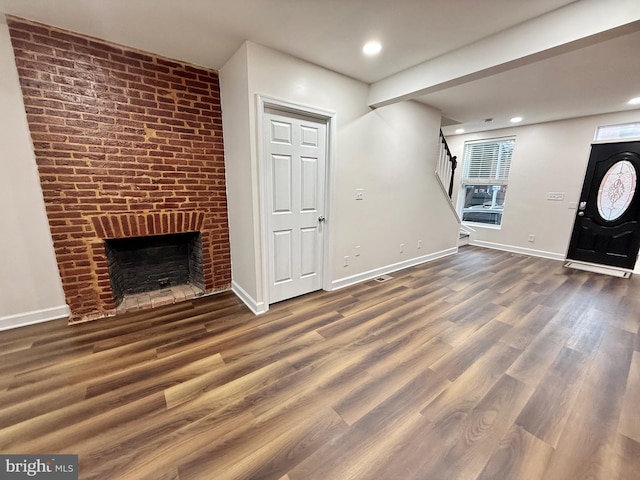 123 E Cross St, Baltimore, MD 21230 - unfurnished living room featuring stairway, wood finished floors, a brick fireplace, and recessed lighting