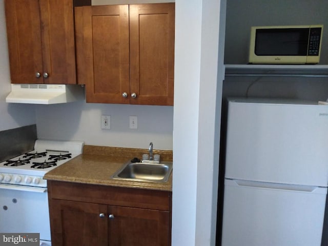 5500 Friendship Blvd Unit 1805N, Chevy Chase, MD 20815 - kitchen with white appliances, under cabinet range hood, and brown cabinets
