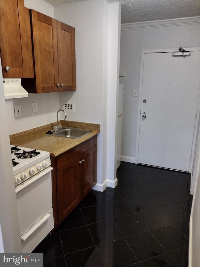 5500 Friendship Blvd Unit 1805N, Chevy Chase, MD 20815 - kitchen with white gas range oven, exhaust hood, dark tile patterned flooring, a textured ceiling, and ornamental molding
