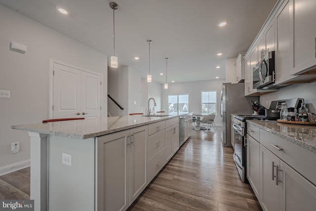 35146 Wright Way, Millsboro, DE 19966 - kitchen featuring stainless steel appliances, an island with sink, wood finished floors, white cabinetry, and recessed lighting