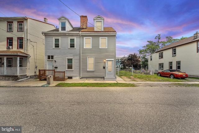 223 Hudson St, Gloucester City, NJ 08030 - back of property at dusk featuring a chimney