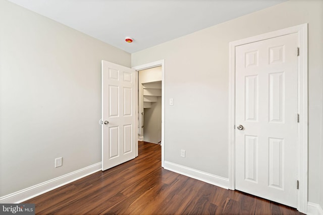 223 Hudson St, Gloucester City, NJ 08030 - unfurnished bedroom featuring dark wood-style floors and baseboards