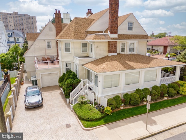 4600 Atlantic Ave, Atlantic City, NJ 08401 - view of front of house with a shingled roof, a balcony, concrete driveway, an attached garage, and a chimney