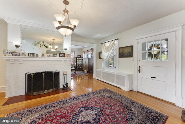 4600 Atlantic Ave, Atlantic City, NJ 08401 - living area with wood finished floors, a chandelier, radiator heating unit, and a fireplace