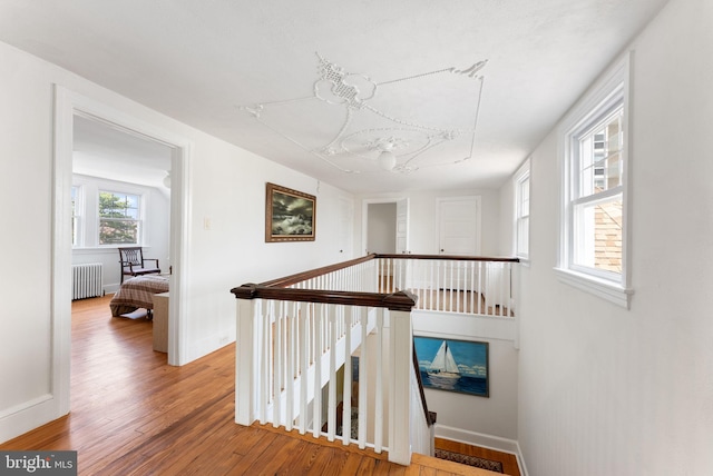 4600 Atlantic Ave, Atlantic City, NJ 08401 - hallway featuring radiator, an upstairs landing, wood finished floors, and a chandelier
