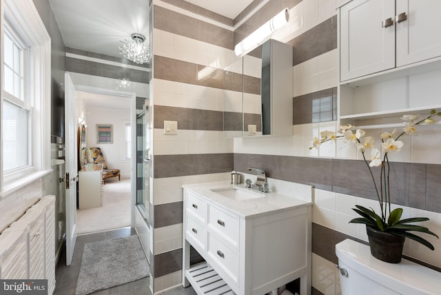 4600 Atlantic Ave, Atlantic City, NJ 08401 - full bathroom with tile walls, vanity, a shower with door, radiator heating unit, and tile patterned floors