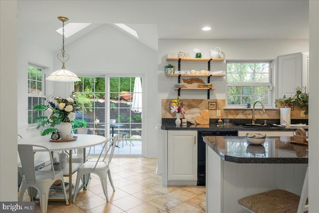 420 Highlands Blvd, Easton, PA 18042 - kitchen featuring dishwasher, backsplash, decorative light fixtures, light tile patterned floors, and dark stone counters