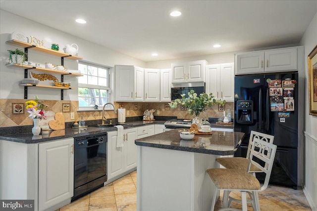 420 Highlands Blvd, Easton, PA 18042 - kitchen featuring black appliances, a kitchen bar, backsplash, white cabinets, and a center island